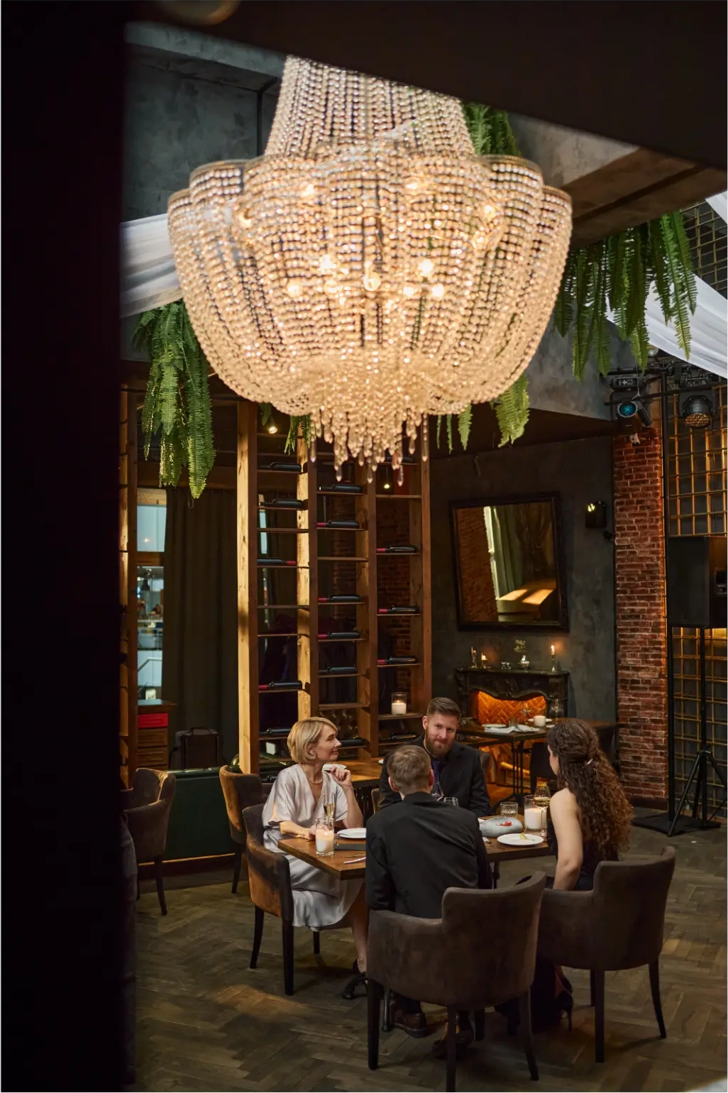 An elegant candlelit dinner beneath chandeliers for a private event